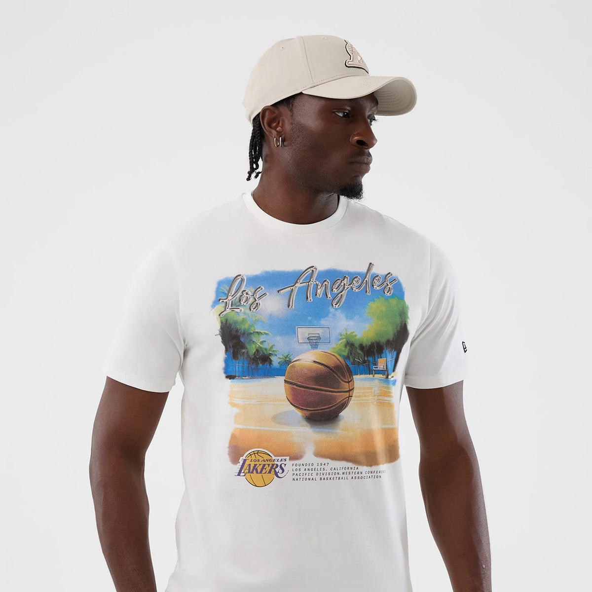 The model is wearing this NBA Beach Graphic LA Lakers T-Shirt in white. 3
