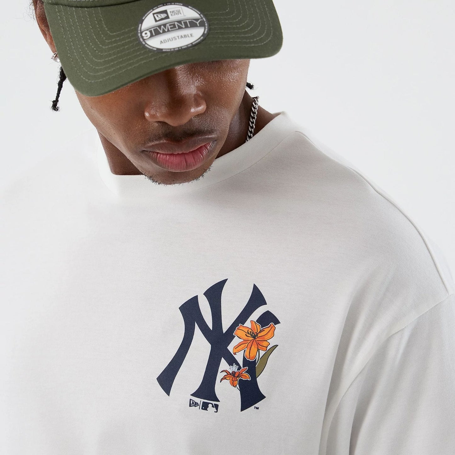 The model is wearing this MLB Floral New York Yankees Oversized T-Shirt in white. 8