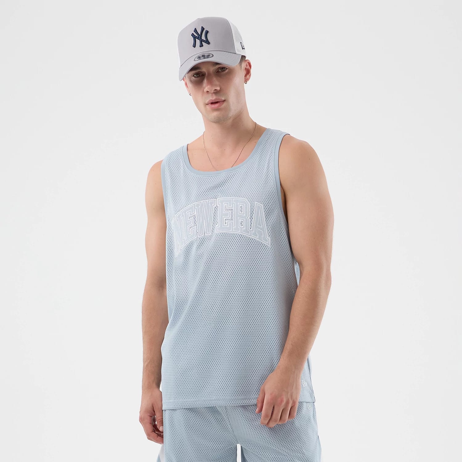 The model is wearing this New Era Mesh Oversized Tank Top in pastel blue. 1