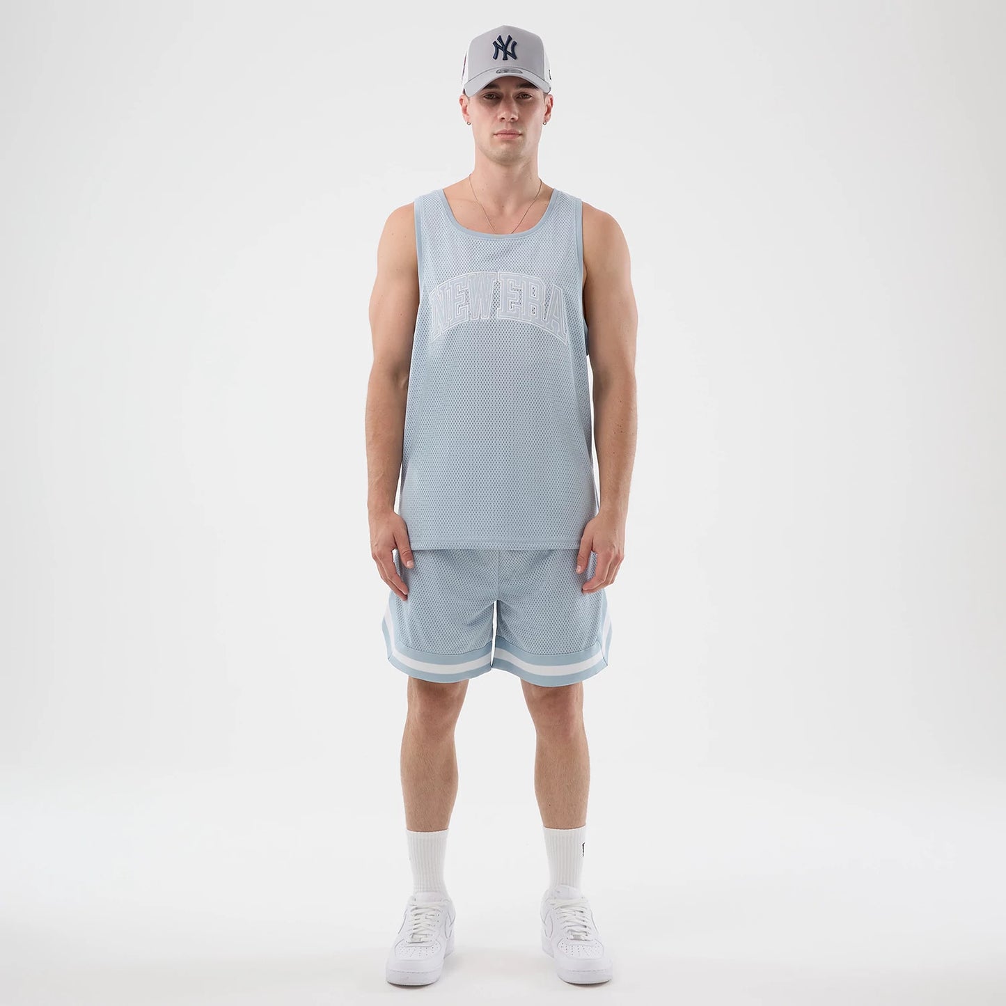 The model is wearing this New Era Mesh Oversized Tank Top in pastel blue. 8