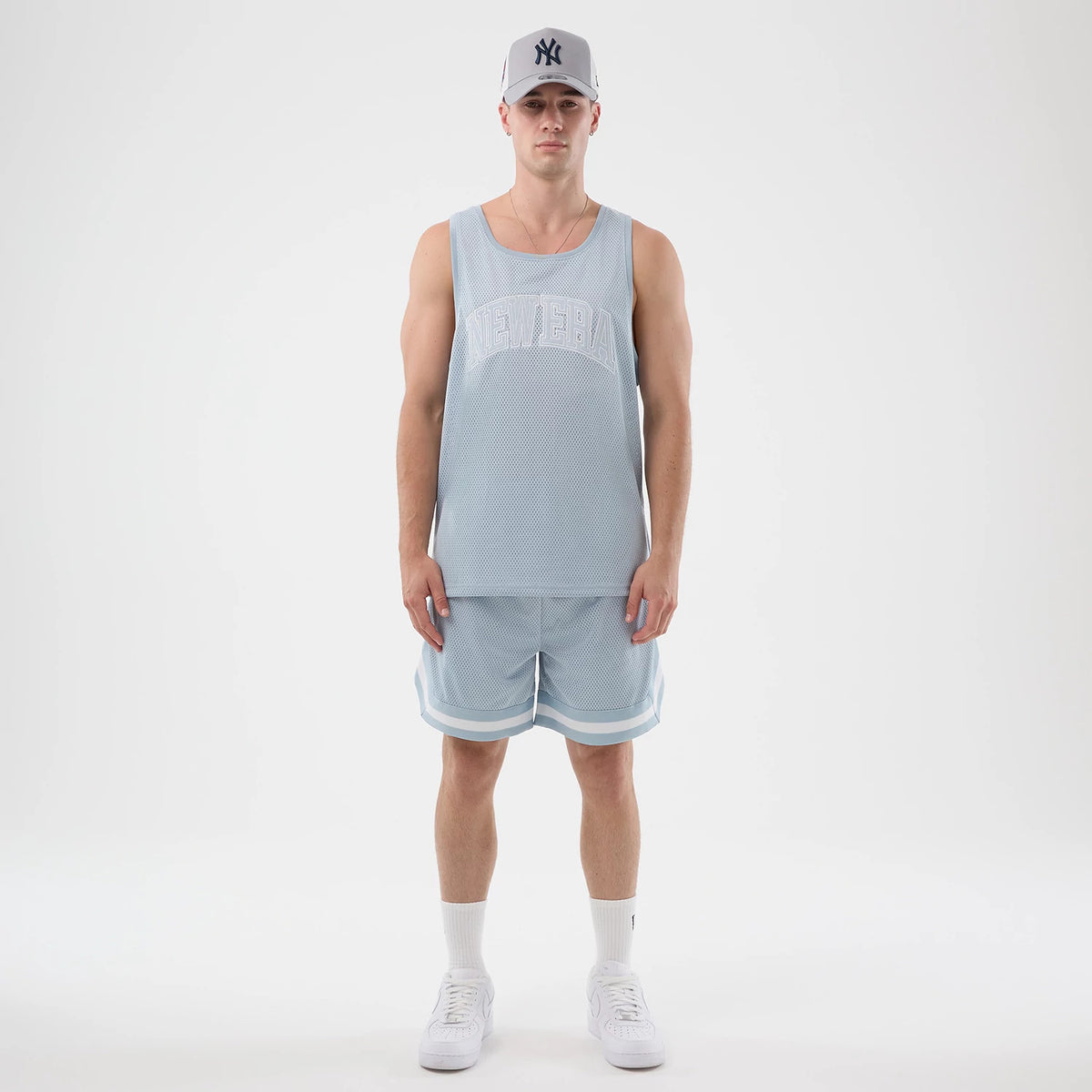 The model is wearing this New Era Mesh Oversized Tank Top in pastel blue. 8