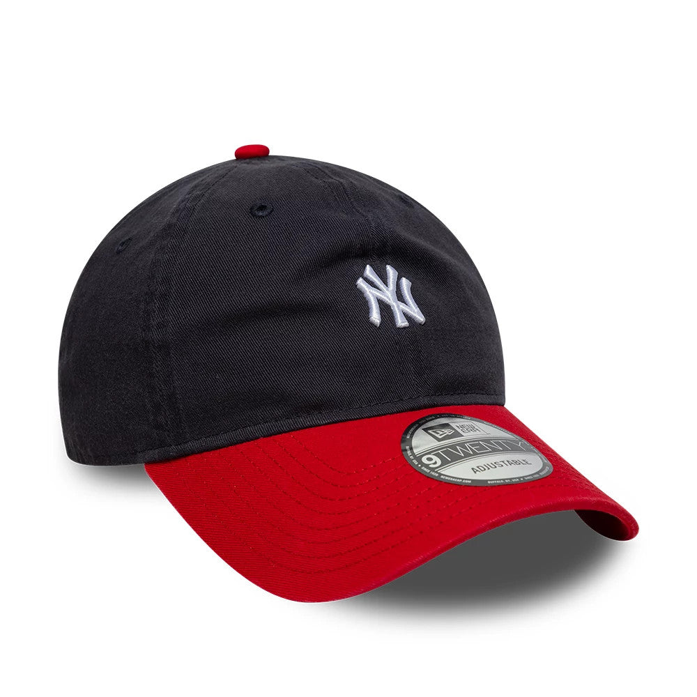 New York Yankees MLB Washed Contrast Navy New Era 9TWENTY Adjustable Cap, three-quarter view showing the raised white NY logo on the front navy panel, curved red visor with a 9TWENTY size sticker, and matching red top button.