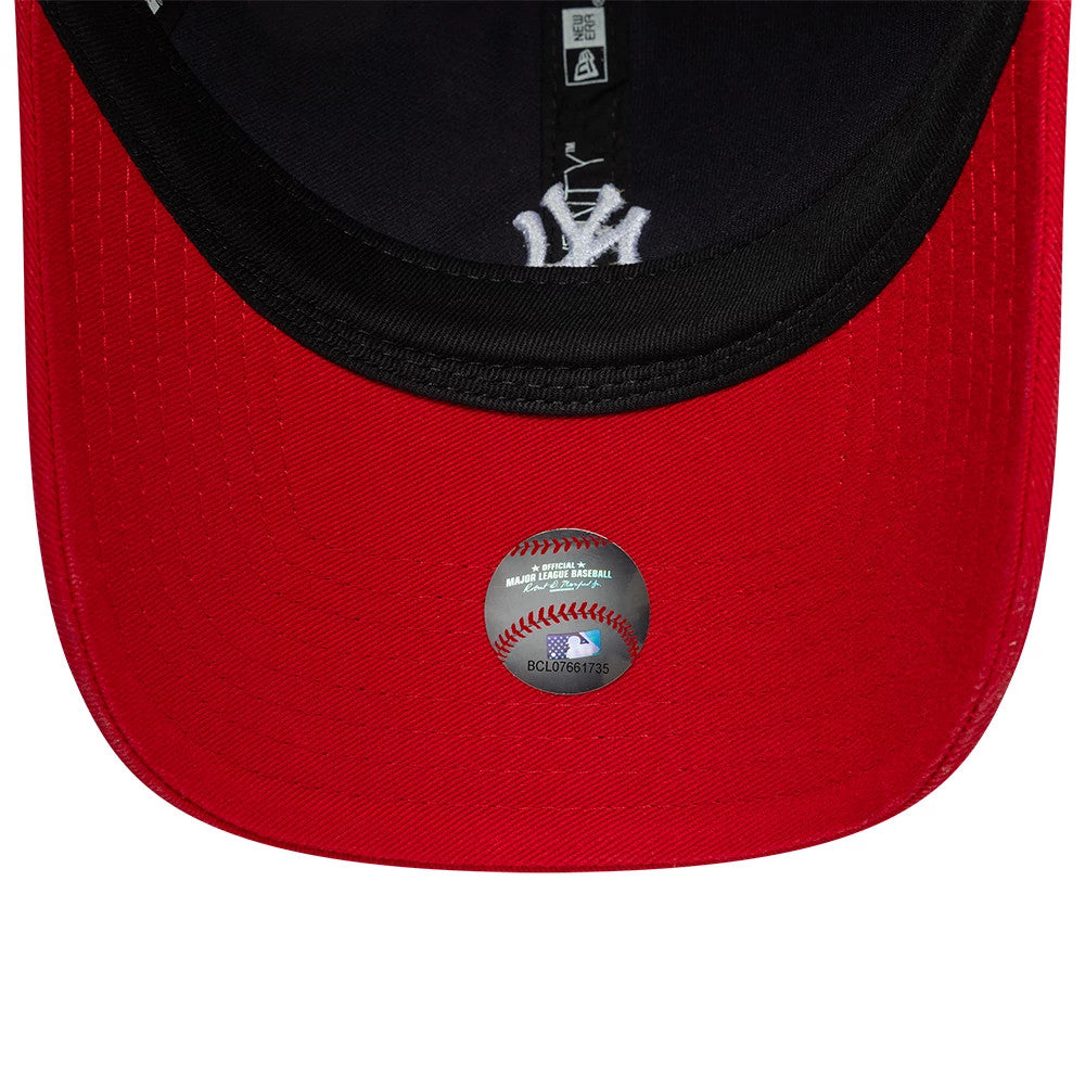 New York Yankees MLB Washed Contrast Navy New Era 9TWENTY Adjustable Cap, inside view featuring a black sweatband, red undervisor with a holographic baseball sticker, and the Yankees logo on the navy fabric taping.