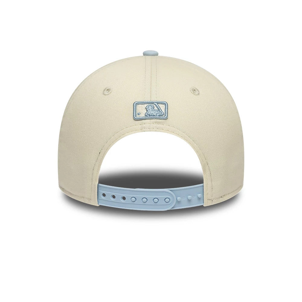 New York Yankees MLB Side Script Cream New Era 9FORTY M-Crown Adjustable Cap, rear view showing a light blue embroidered MLB Batterman logo at the centre back, light blue adjustable snap closure, and matching top button on the cream crown.