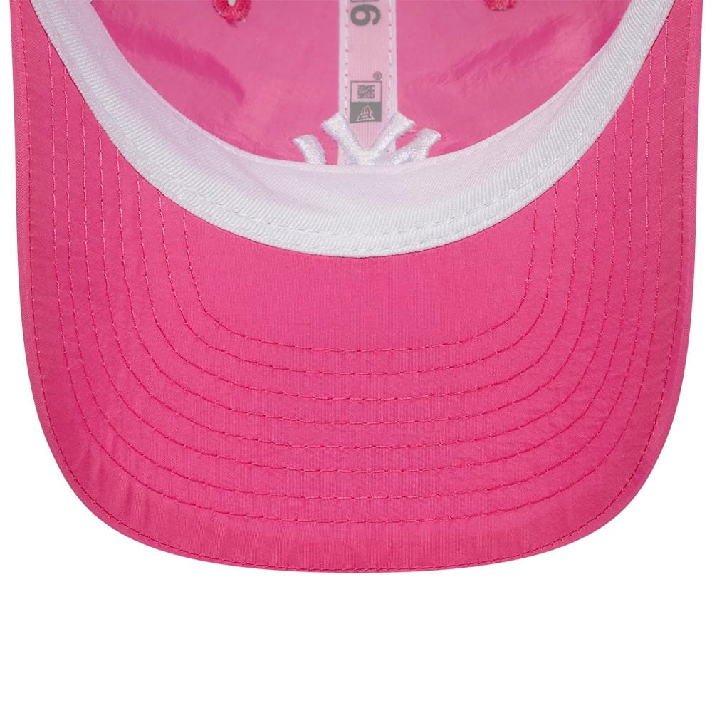 New York Yankees Child MLB Sun Shield Pink New Era 9FORTY Adjustable Cap, inside view showing the pink undervisor and white internal sweatband, with pink taping featuring the New Era logo and stitching detail along the visor edge.