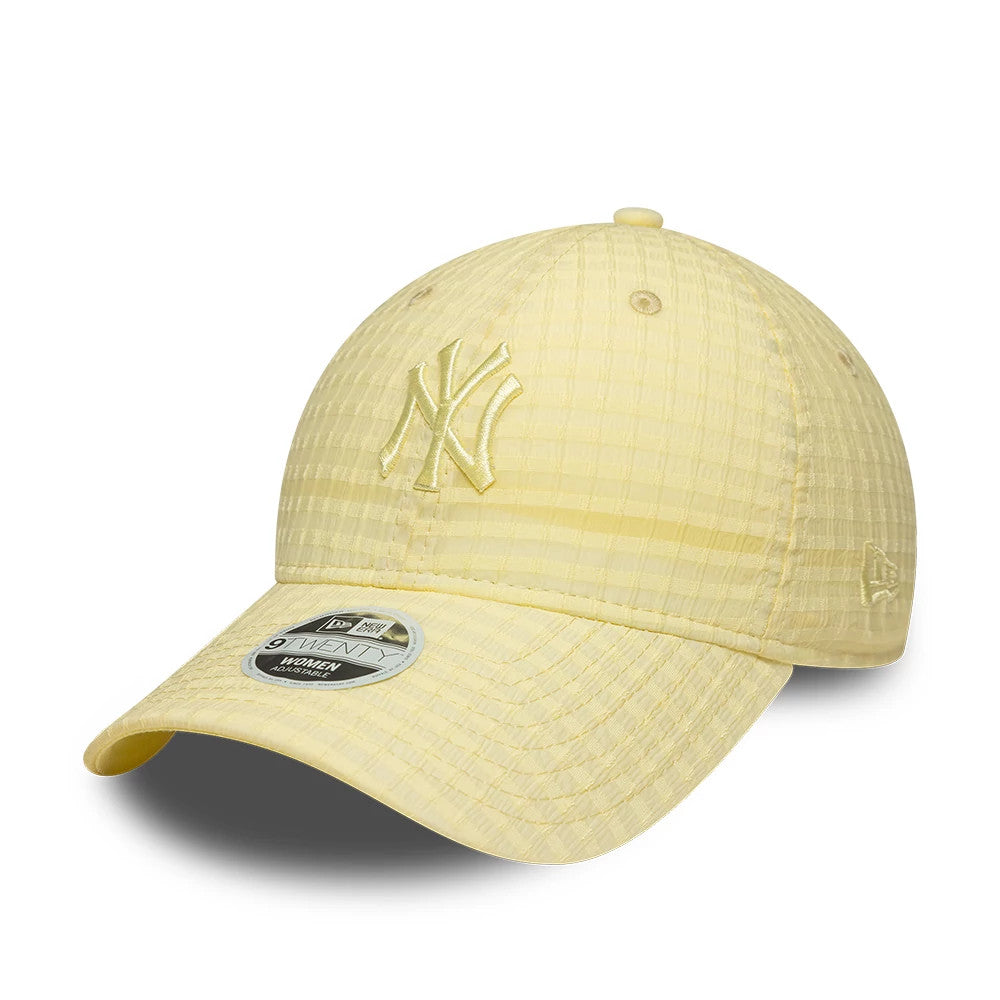 New York Yankees Womens MLB Seersucker Pastel Yellow New Era 9TWENTY Adjustable Cap, three-quarter view showing the NY logo embroidered on the front panel, a curved visor with 9TWENTY size sticker, and the New Era flag logo on the left side.