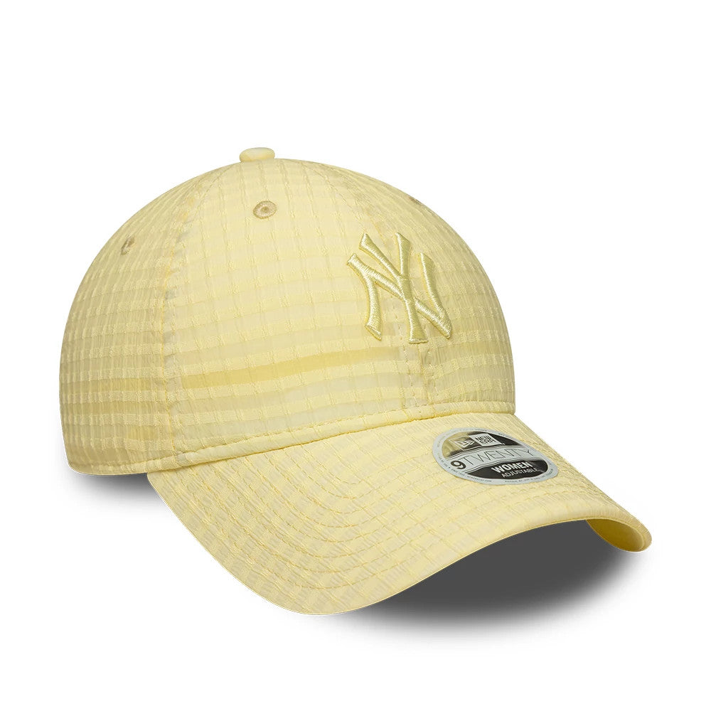 New York Yankees Womens MLB Seersucker Pastel Yellow New Era 9TWENTY Adjustable Cap, three-quarter view showing the embroidered NY logo on the front panel in matching pastel yellow, curved visor with 9TWENTY size sticker, and seersucker texture.