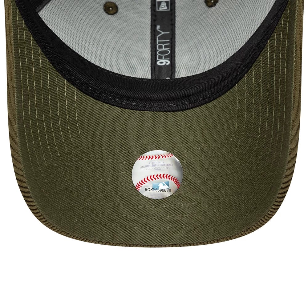New York Yankees MLB Soft Cord Dark Green New Era 9FORTY Adjustable Cap, inside view showing the black sweatband with an embroidered 9FORTY label, dark green undervisor, and a round baseball-themed sticker in the centre.