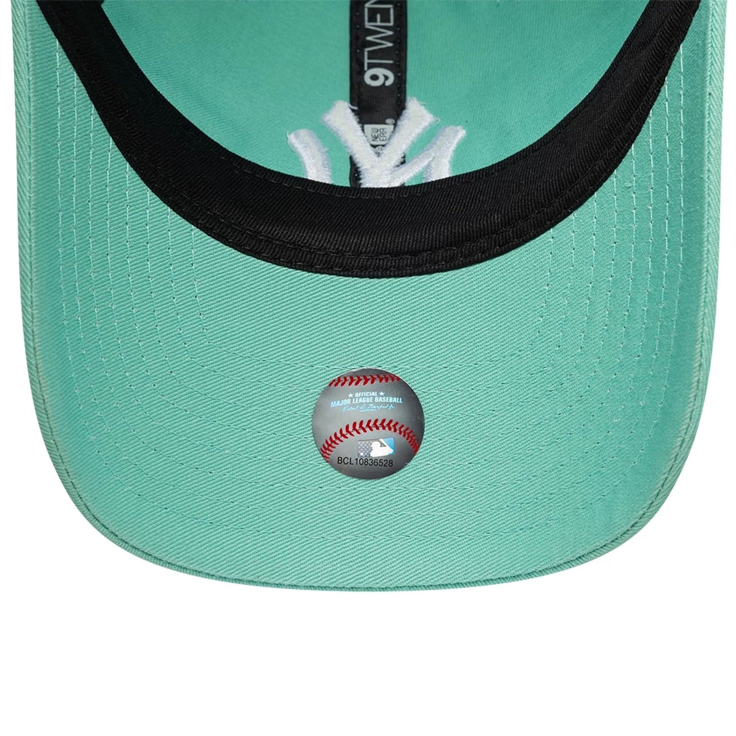 New York Yankees MLB League Essential Pastel Green New Era 9TWENTY Adjustable Cap, inside view showing black taping with the 9TWENTY label, a black sweatband, pastel green undervisor, and a sticker featuring the MLB logo on the inner panel.
