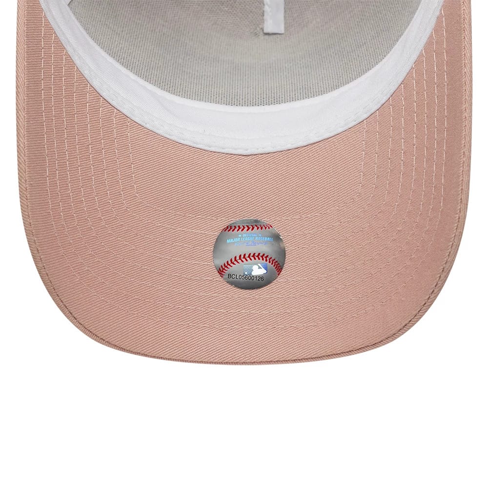 New York Yankees MLB Outline Pastel Pink New Era 9FORTY E-Frame Trucker Adjustable Cap, inside view showing the white sweatband, light grey mesh panels, and the official silver MLB sticker on the pastel pink visor.