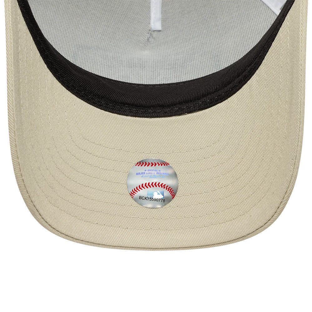 New York Yankees MLB Patch Cream New Era 9FORTY M-Crown A-Frame Trucker Adjustable Cap, inside view showing the black sweatband lining the curved cream visor, grey undervisor, and the official MLB holographic sticker placed centrally.