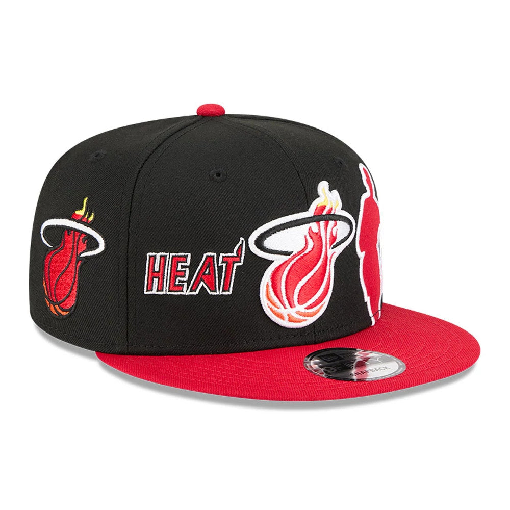 Miami Heat NBA Hardwood Classic ASG Black New Era 9FIFTY Snapback Adjustable Cap, three-quarter view showing the large embroidered Heat logo and text on the front panels, contrasted with a red flat visor and 9FIFTY size sticker on top.