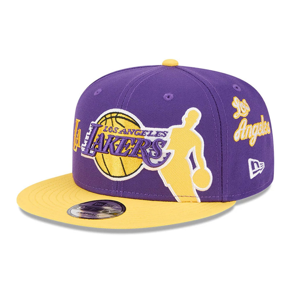 LA Lakers NBA Hardwood Classic ASG Purple New Era 9FIFTY Snapback Adjustable Cap, front view showing a large embroidered Lakers logo with a purple and yellow basketball graphic, yellow visor with a 9FIFTY size sticker.