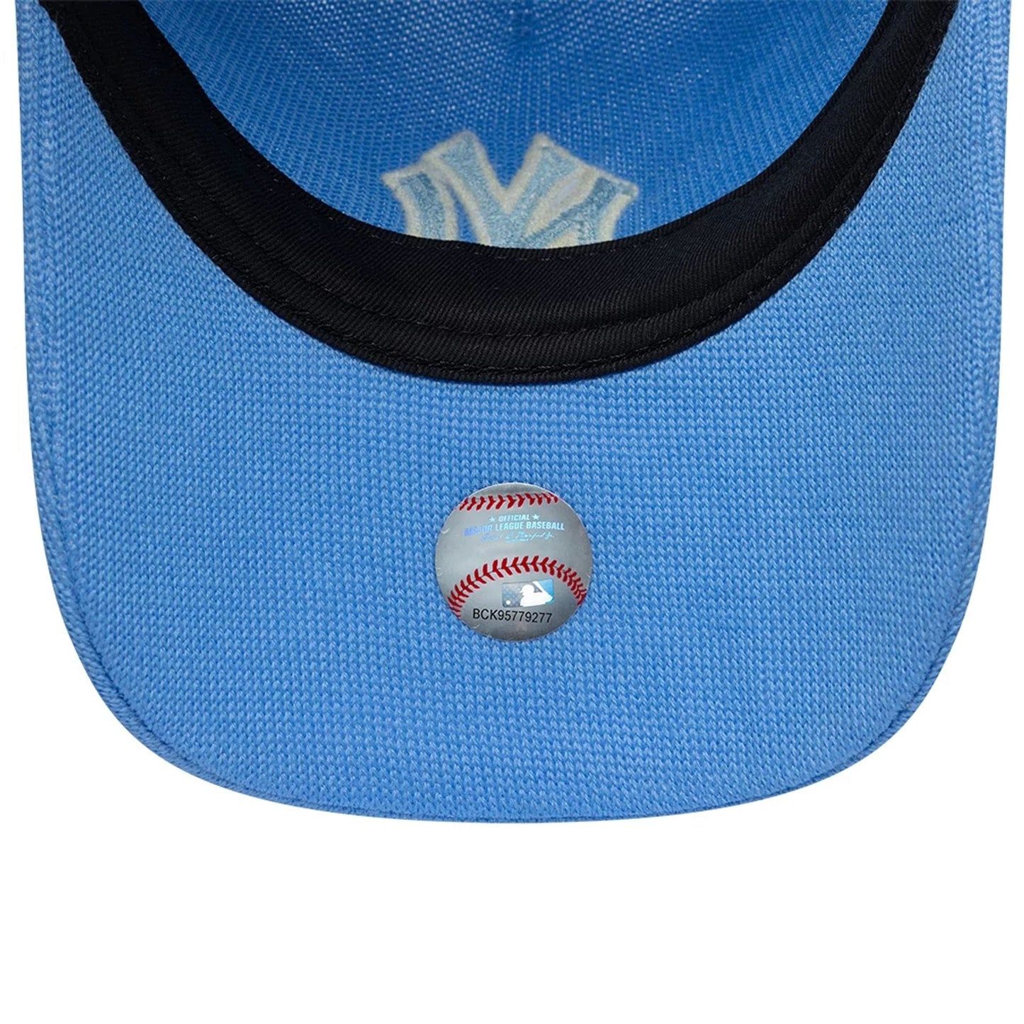 New York Yankees MLB Merino Wool Pastel Blue New Era 9TWENTY Adjustable Cap, inside view showing the black sweatband, a pastel blue undervisor, and a baseball-shaped sticker with MLB branding placed centrally.