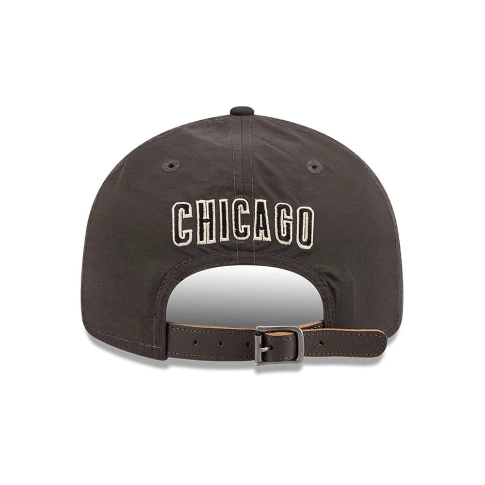 Chicago Cubs MLB Nylon Black Retro Crown New Era 9FIFTY Adjustable Cap, rear view showing the white embroidered Chicago lettering across the back panels, with an opening above the brown adjustable strap and grey eyelets on the black crown.