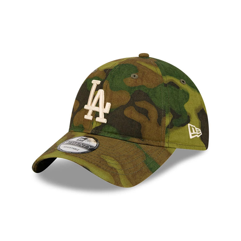 LA Dodgers MLB Ripstop Camo New Era 9TWENTY Adjustable Cap, three-quarter view showing the cream LA logo in raised embroidery on the front panel, complemented by a green and brown camo pattern and a New Era flag logo on the left side.