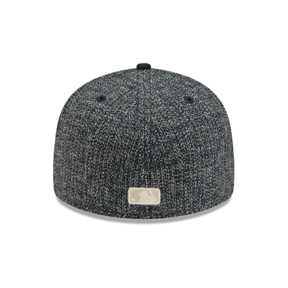 Chicago Cubs MLB Tweedy Cotton Black New Era 59FIFTY Fitted Cap, rear view showing an off-white embroidered MLB Batterman logo at the centre of the textured black tweed back panels, with a black top button and matching fabric eyelets.