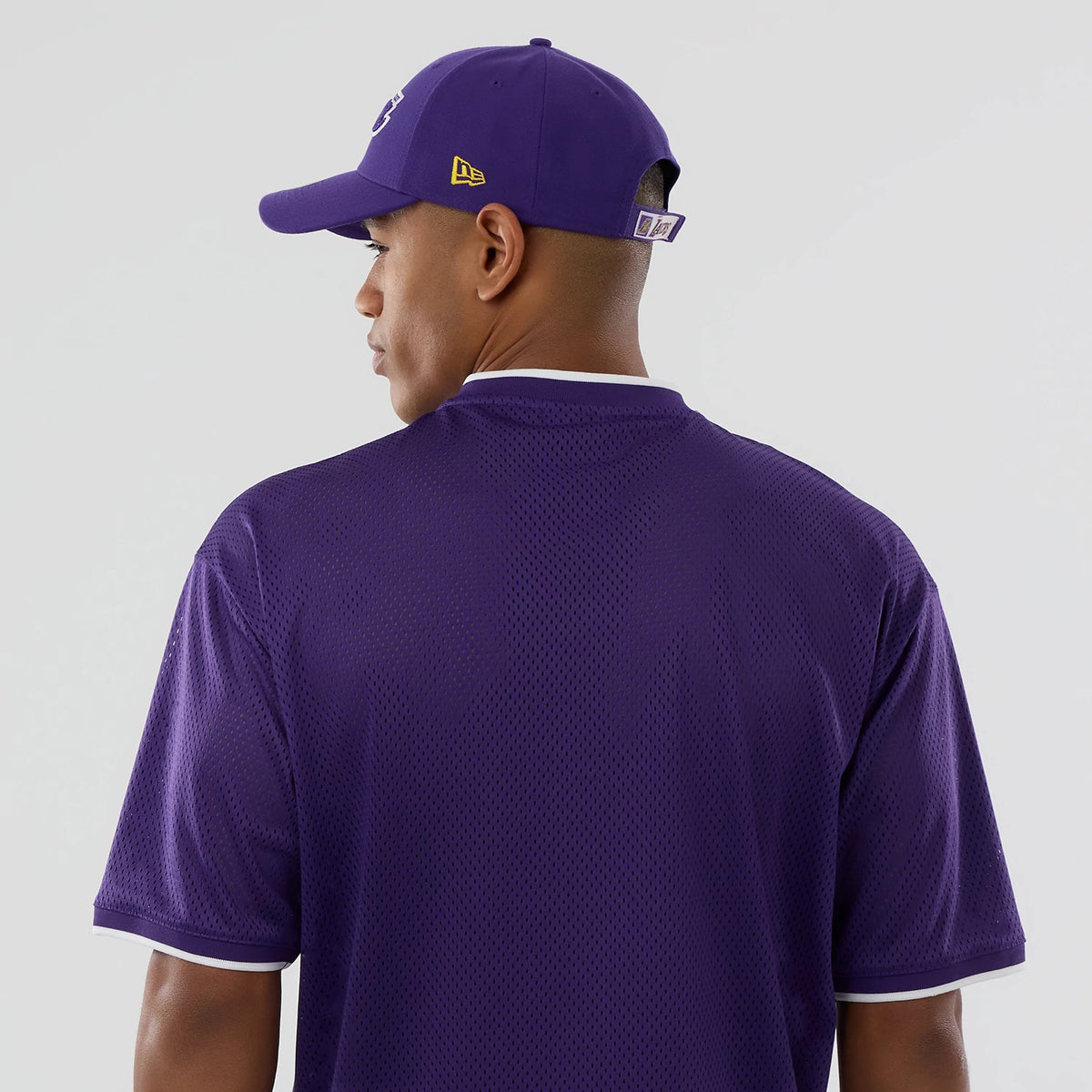 The model is wearing this NBA Mesh LA Lakers Oversized T-Shirt in purple. 7