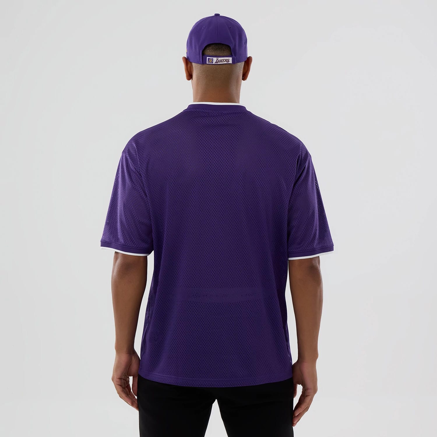 The model is wearing this NBA Mesh LA Lakers Oversized T-Shirt in purple. 2