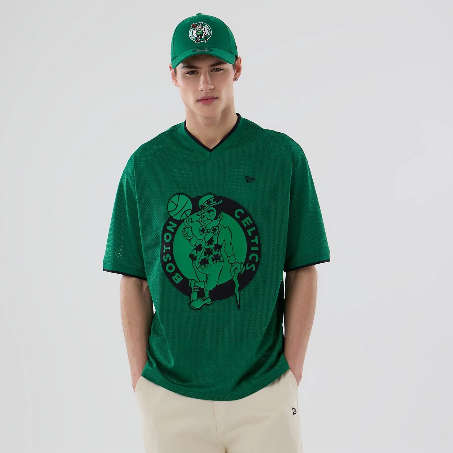 The model is wearing this NBA Mesh Boston Celtics Oversized T-Shirt in green. 1