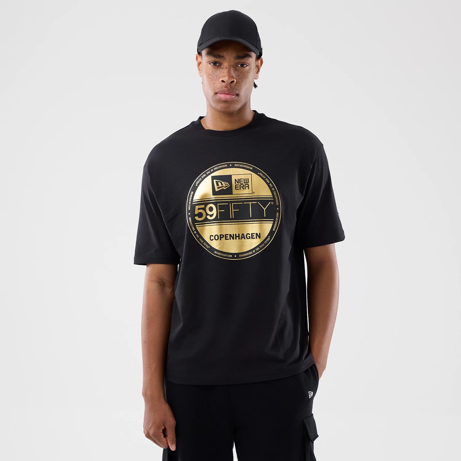 The model is wearing this New Era Sticker Copenhagen Oversized T-Shirt in black. 1
