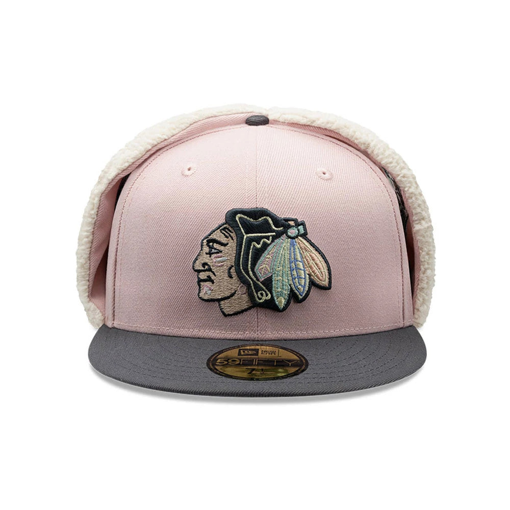Chicago Blackhawks NHL Patch Pastel Pink New Era 59FIFTY Fitted Cap, front view showing a detailed embroidered Native American logo on the structured pastel pink crown, flanked by soft dogear flaps, paired with a grey flat visor.