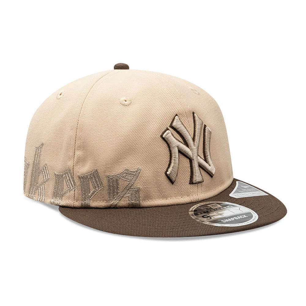 New York Yankees MLB Gothic Script Beige Retro Crown New Era 9FIFTY Cap, three-quarter view featuring a raised embroidered NY logo in beige on the front panel, brown flat visor, and 9FIFTY size sticker on the visor's left side.