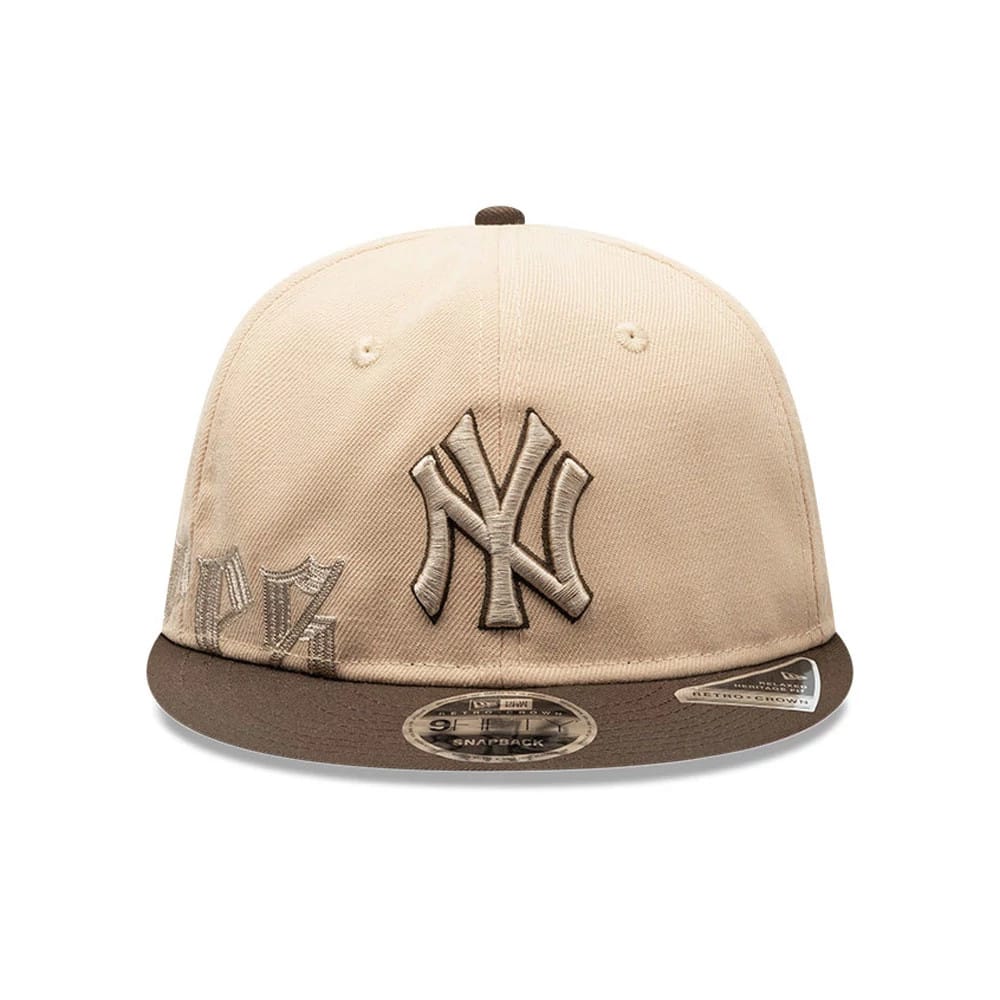 New York Yankees MLB Gothic Script Beige Retro Crown New Era 9FIFTY Cap, front view showing a brown raised embroidered NY logo on the beige crown, accented by additional script details on the left panel.
