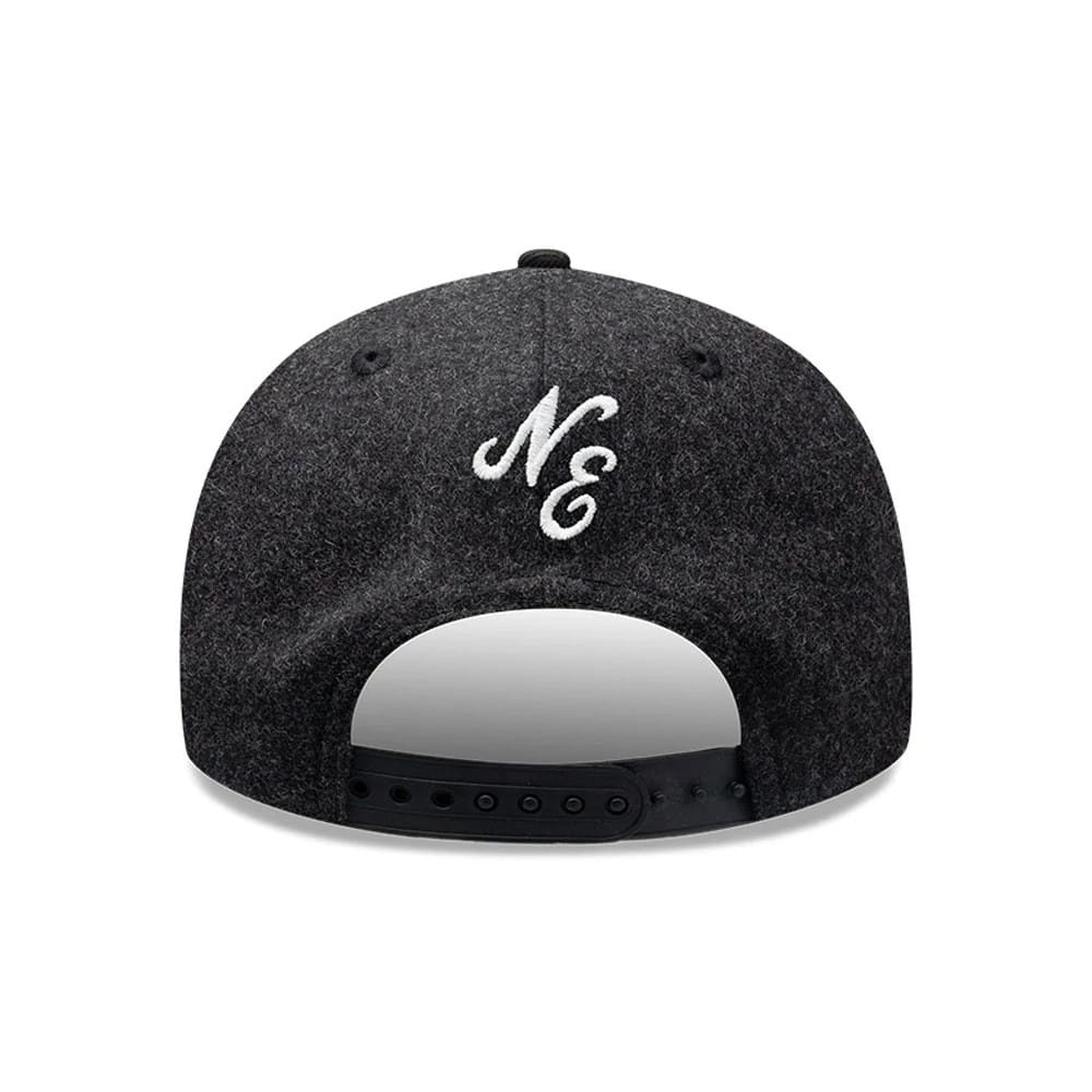 New Era Melton Wool Black Retro Crown 9FIFTY Cap, rear view showing the white embroidered NE logo centred above the adjustable black snapback closure, with a structured black wool crown and matching eyelets for a classic finish.