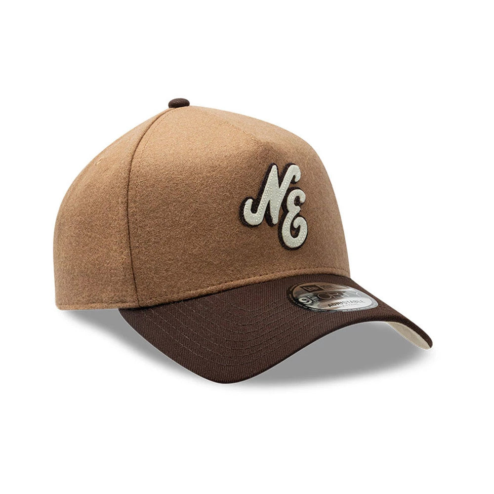 New Era Melton Wool Beige 9FORTY A-Frame Cap, three-quarter view showing an embroidered NE logo on the front panel in cream and black, a dark brown curved visor, and a 9FORTY size sticker on the visor.