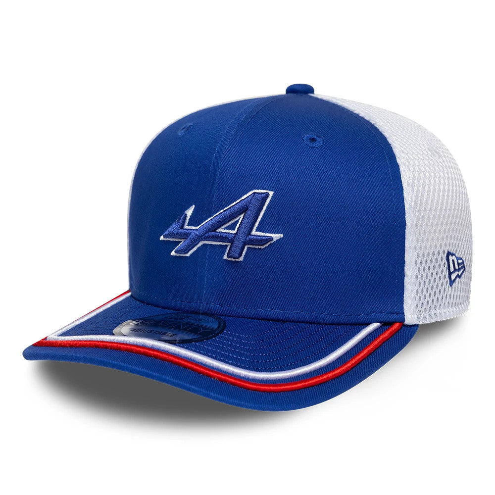 Alpine Racing WEC 2025 Blue New Era 9SEVENTY Stretch Snap Cap, three-quarter view showing a blue and white embroidered A logo on the front panel, a blue visor with red and white piping, and a 9SEVENTY size sticker.