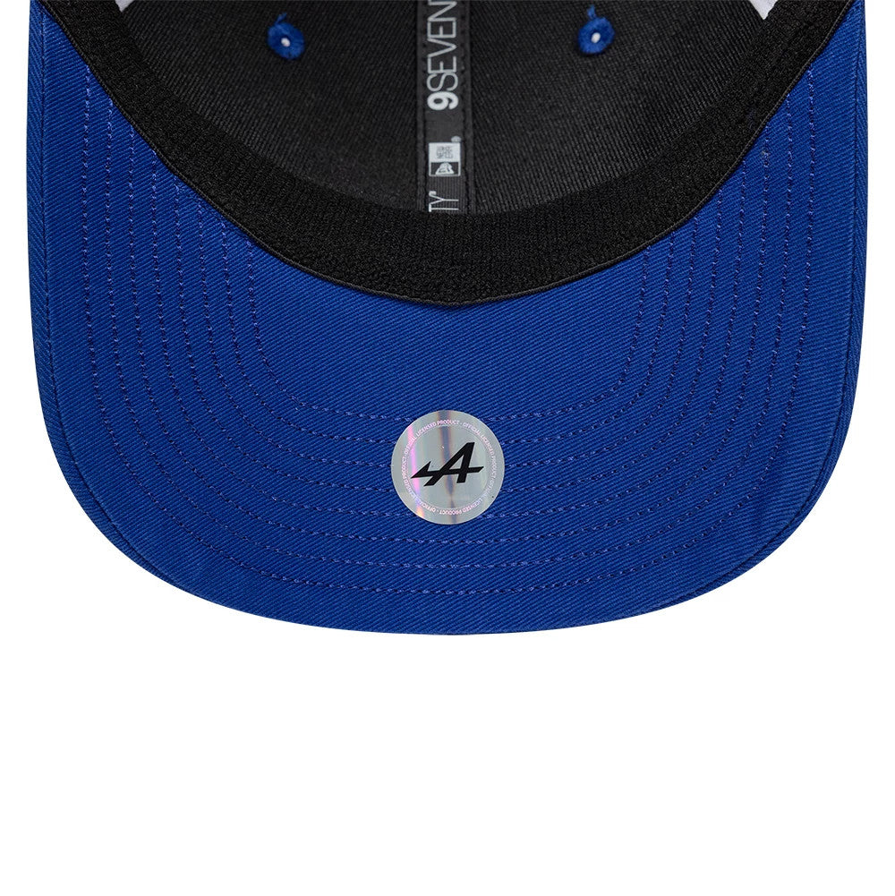 Alpine Racing WEC 2025 Blue New Era 9SEVENTY Stretch Snap Cap, inside view showing the black sweatband, blue undervisor with a A logo sticker, and detailed blue stitching, with New Era branding on the taping.