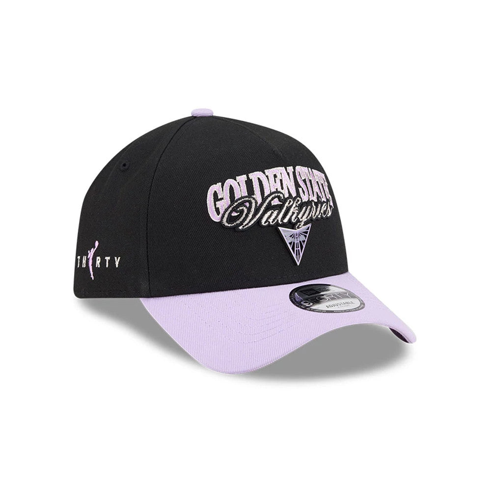 Golden State Valkyries WNBA Tip Off 2026 Black New Era 9FORTY A-Frame Adjustable Cap, three-quarter view showing lilac embroidered text on the front panel, lilac flat visor with a 9FORTY size sticker, and lilac logo on the left side.