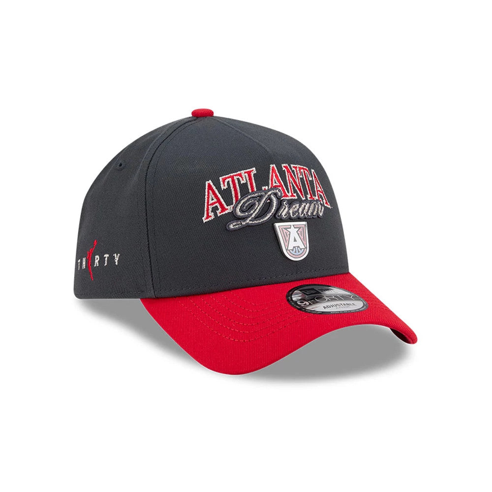 Atlanta Dream WNBA Tip Off 2026 Black New Era 9FORTY A-Frame Adjustable Cap, three-quarter view showing raised red and silver team logo embroidery on the front, red visor with a 9FORTY size sticker, and black crown with a red top button.