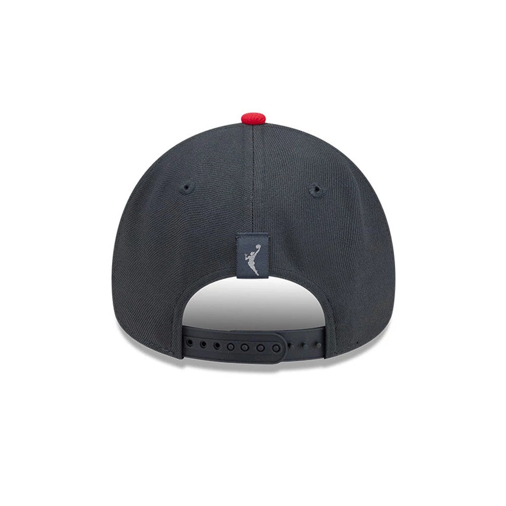 Atlanta Dream WNBA Tip Off 2026 Black New Era 9FORTY A-Frame Adjustable Cap, rear view showing the WNBA logo embroidered in grey above the adjustable black strap, with a red top button and matching black eyelets on the structured crown.