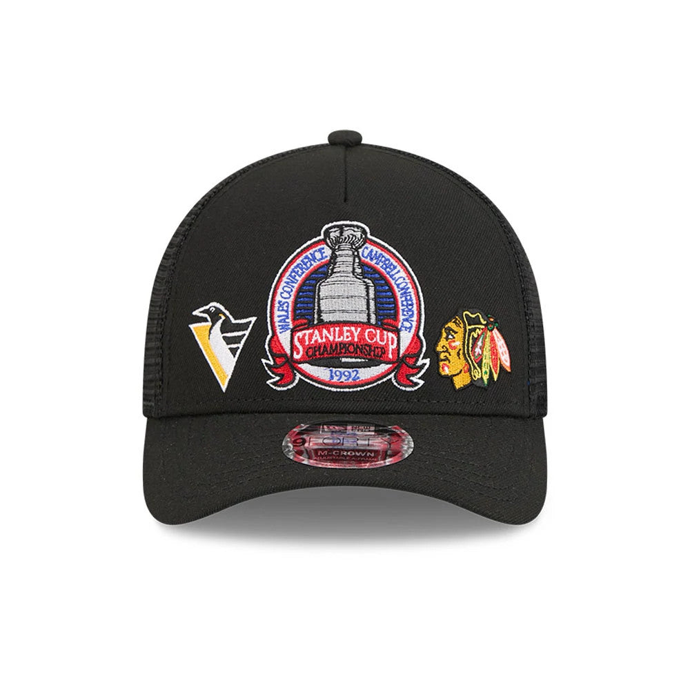 Penguins NHL Stanley Cup Black New Era 9FORTY M-Crown A-Frame Trucker Adjustable Cap, front view showing the central embroidered 1992 Stanley Cup Champions logo, with Penguins and Blackhawks logos on either side.