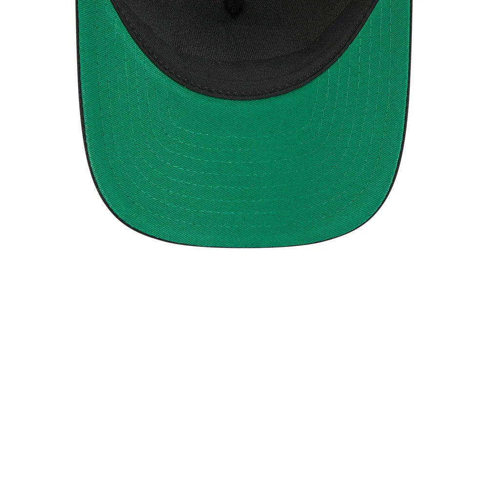 Penguins NHL Stanley Cup Black New Era 9FORTY M-Crown A-Frame Trucker Adjustable Cap, inside view showing a bright green undervisor against a black sweatband, with rows of reinforced stitching along the visor edge.