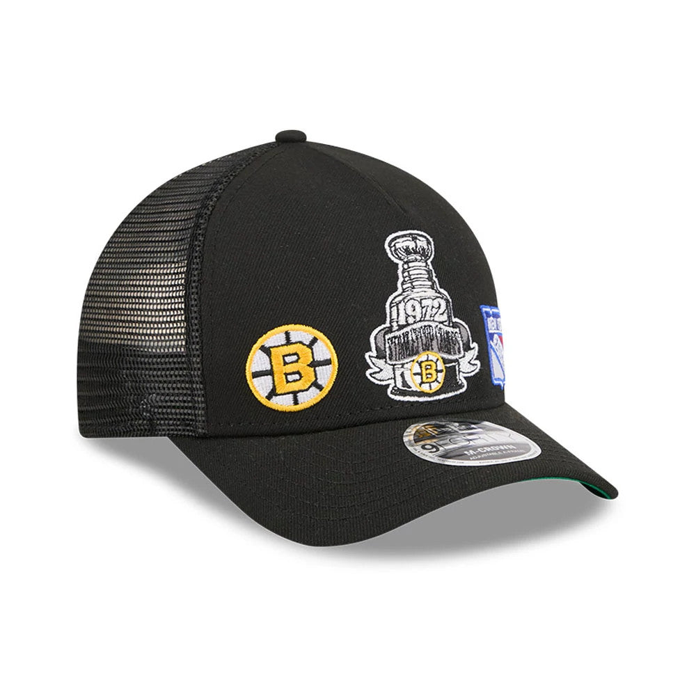 Bruins NHL Stanley Cup Black New Era 9FORTY M-Crown A-Frame Trucker Adjustable Cap, front view showing a black structured crown with a yellow B logo and embroidered Stanley Cup graphic, plus a 9FORTY size sticker on the black curved visor.