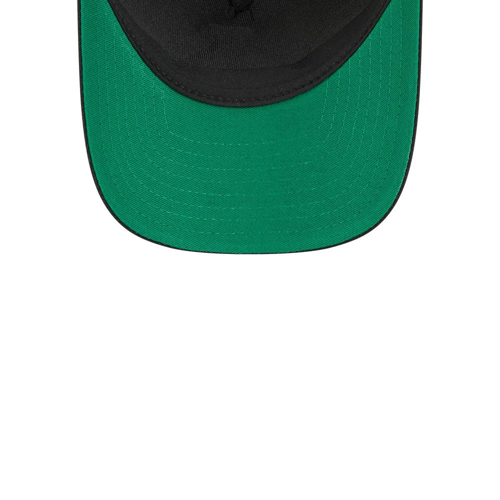 Bruins NHL Stanley Cup Black New Era 9FORTY M-Crown A-Frame Trucker Adjustable Cap, inside view showing a bright green undervisor against the cap's black interior, with the stitching pattern along the edge of the structured crown.