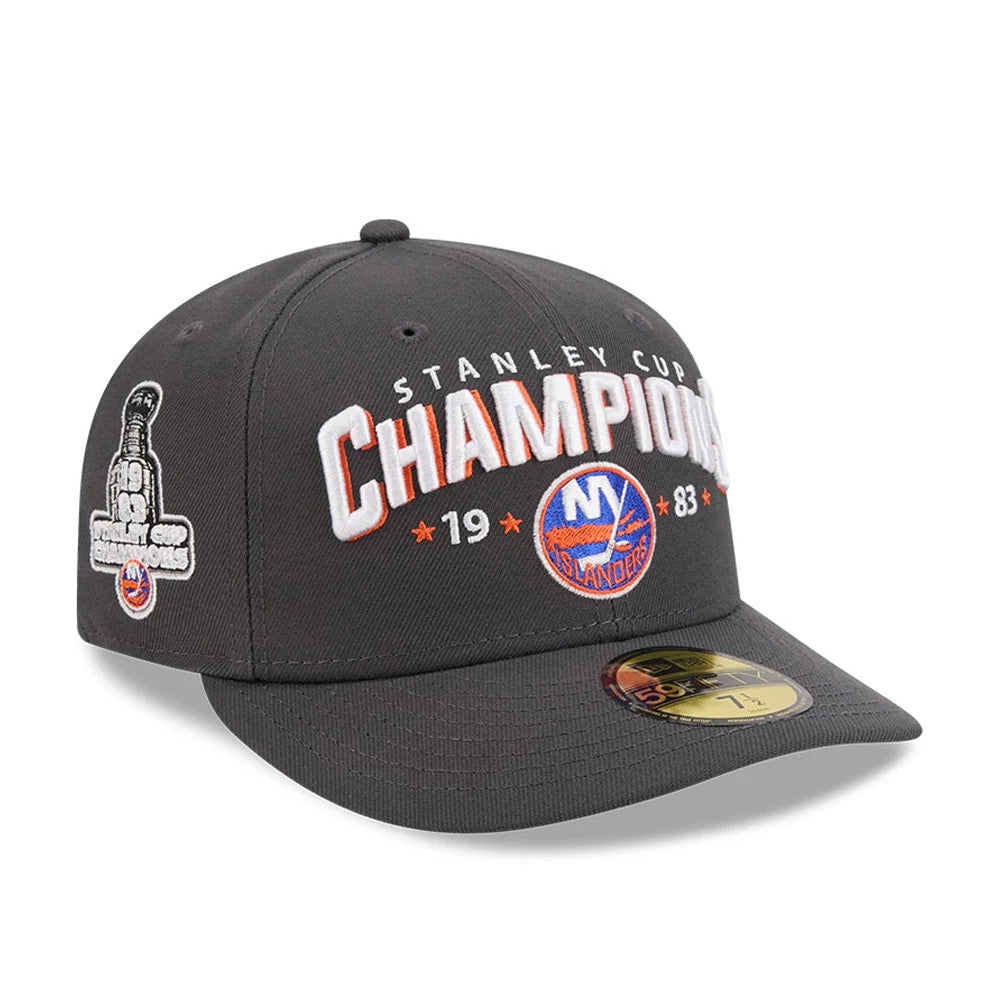 New York Islanders NHL Stanley Cup Champions Dark Grey New Era 59FIFTY Fitted Cap, three-quarter view showing raised white Champions embroidery with orange accents on the front, large side logo on left.