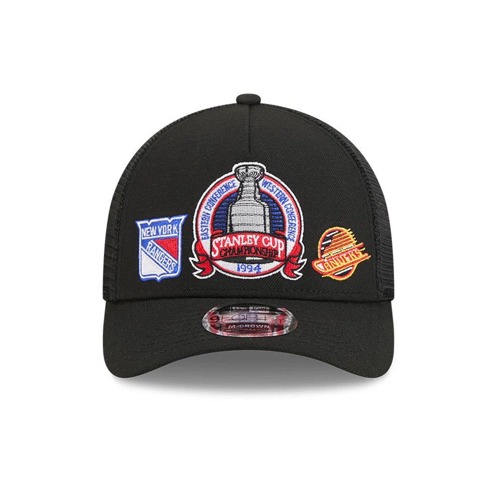 Rangers NHL Stanley Cup Black New Era 9FORTY M-Crown A-Frame Trucker Adjustable Cap, front view showing the central embroidered Stanley Cup Championship patch, flanked by New York Rangers and Vancouver Canucks logos.