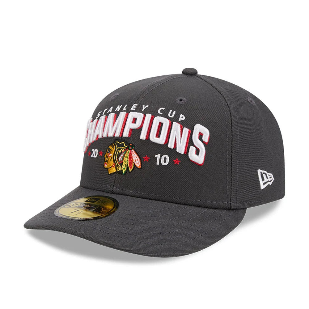 Chicago Blackhawks NHL Stanley Cup Champions Dark Grey New Era 59FIFTY Fitted Cap, three-quarter view showing raised white and red embroidered Stanley Cup Champions lettering with a 2010 logo on the grey front panel.