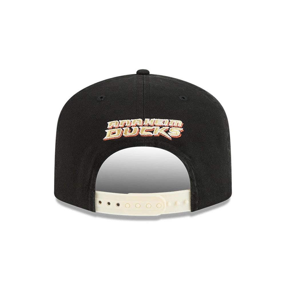 Anaheim Ducks NHL Stanley Cup Champions Black New Era 19TWENTY Adjustable Cap, rear view showing embroidered Anaheim Ducks lettering in white and orange above the beige adjustable strap, on a structured black crown with matching eyelets.