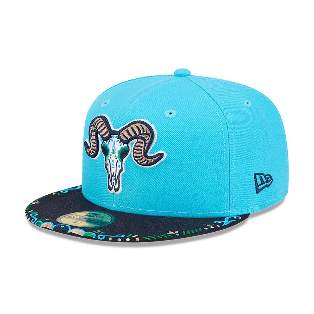 Yard Goats MiLB La Copa 2026 Bright Blue New Era 59FIFTY Fitted Cap, front view showing a large brown and white ram skull embroidered on the front panel, with a navy visor decorated with colourful floral patterns and a gold 59FIFTY size sticker.