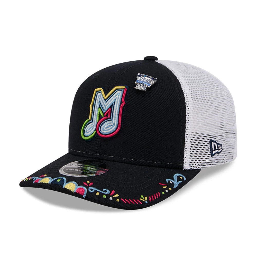 Memphis Redbirds MiLB La Copa 2026 Navy New Era 9SEVENTY Stretch Snap Adjustable Cap, three-quarter view showing the colourful embroidered M logo on the front panel, a white mesh back, decorative visor embroidery.