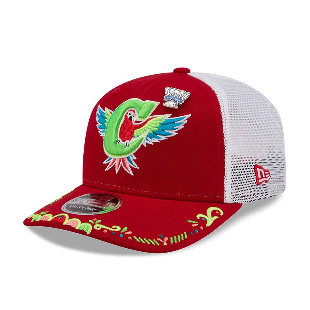 Charlotte Knights MiLB La Copa 2026 Red New Era 9SEVENTY Stretch Snap Adjustable Cap, three-quarter view showing a colourful parrot and letter C logo embroidered on the front, with a white mesh back and visor embroidery.