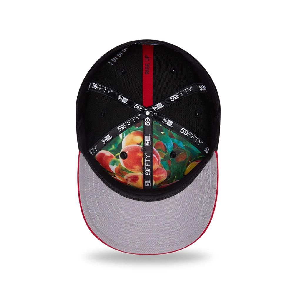 Atlanta Falcons NFL Draft 2026 Black New Era 59FIFTY Fitted Cap, inside view showing the colourful fruit design on the undervisor, black taping with white 59FIFTY logos and black sweatband, combined with a red underside of the top button.