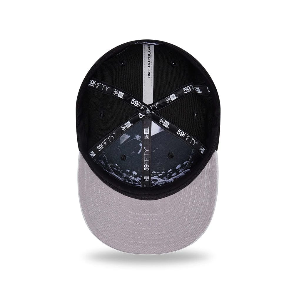 Las Vegas Raiders NFL Draft 2026 Black New Era 59FIFTY Fitted Cap, inside view showing the intricate black and white graphic on the panels, contrasting black 59FIFTY branded taping, and a grey undervisor with black stitching lines.