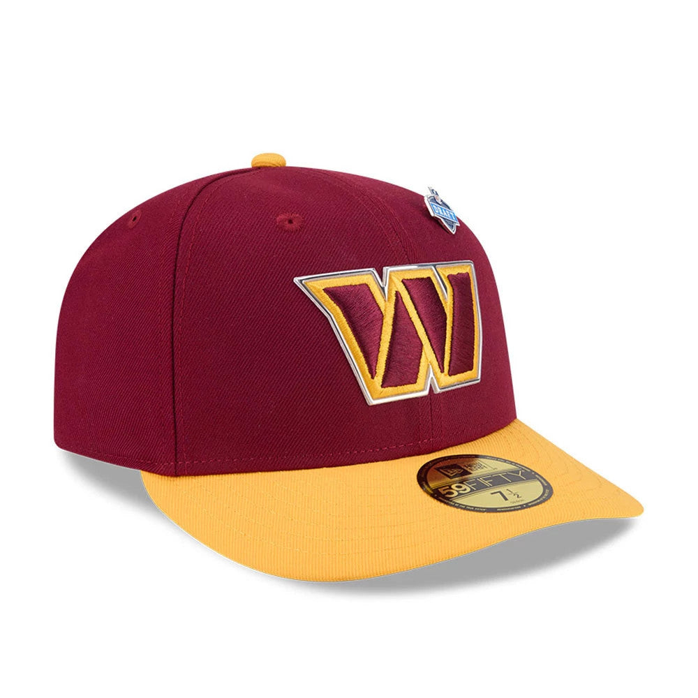Washington Commanders NFL Draft 2026 Dark Red New Era 59FIFTY Fitted Cap, three-quarter view showing a gold and dark red embroidered W logo on the front panel, a contrasting yellow visor with a gold 59FIFTY size sticker, and a small shield pin.
