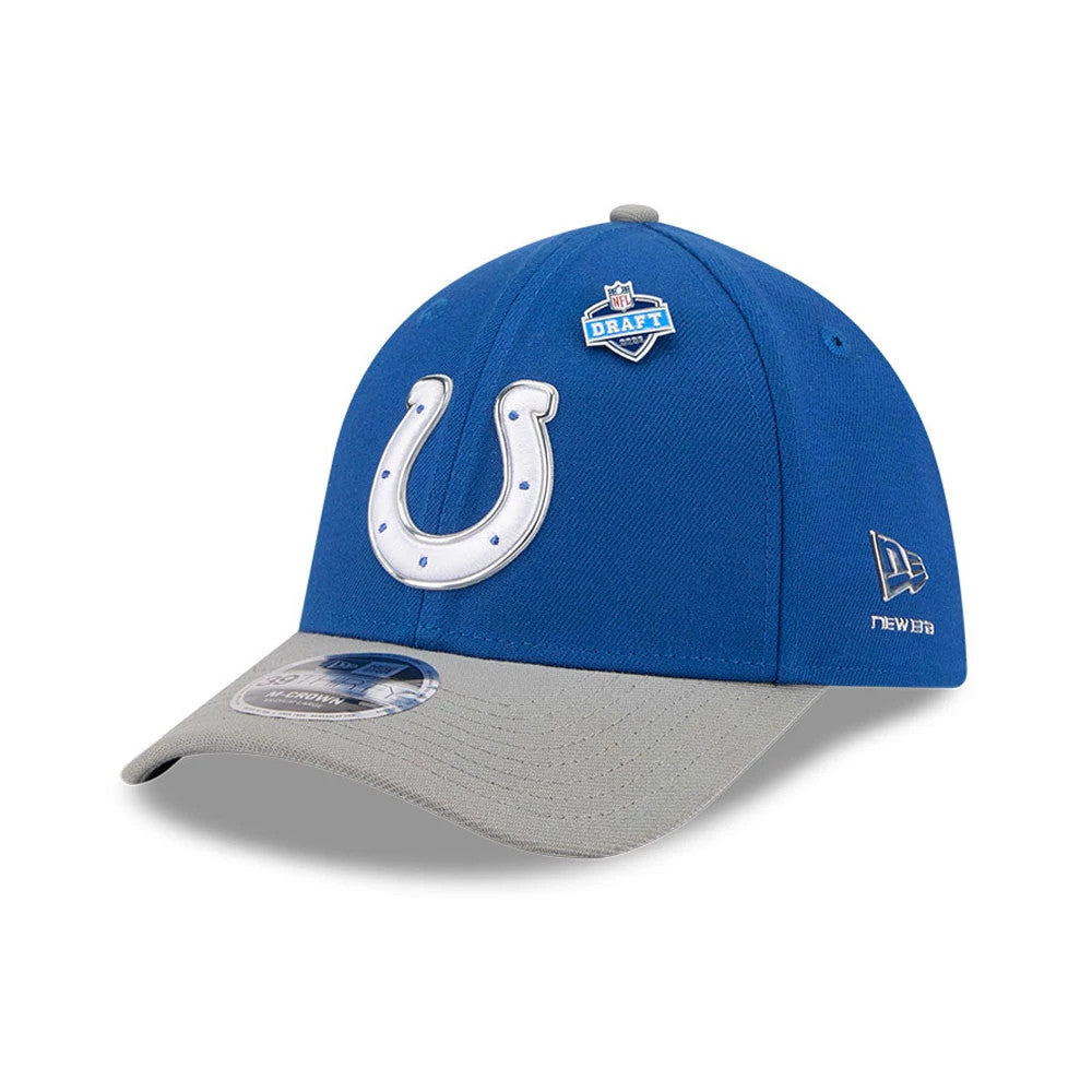 Indianapolis Colts NFL Draft 2026 Blue New Era 39THIRTY M-Crown Stretch Fit Cap, three-quarter view showing a raised white horseshoe logo on the front panel, grey curved visor with a 39THIRTY size sticker, and an NFL Draft badge on the blue crown.